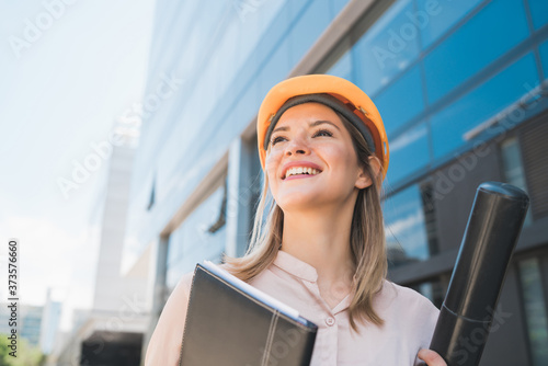 Professional architect woman standing outdoors.