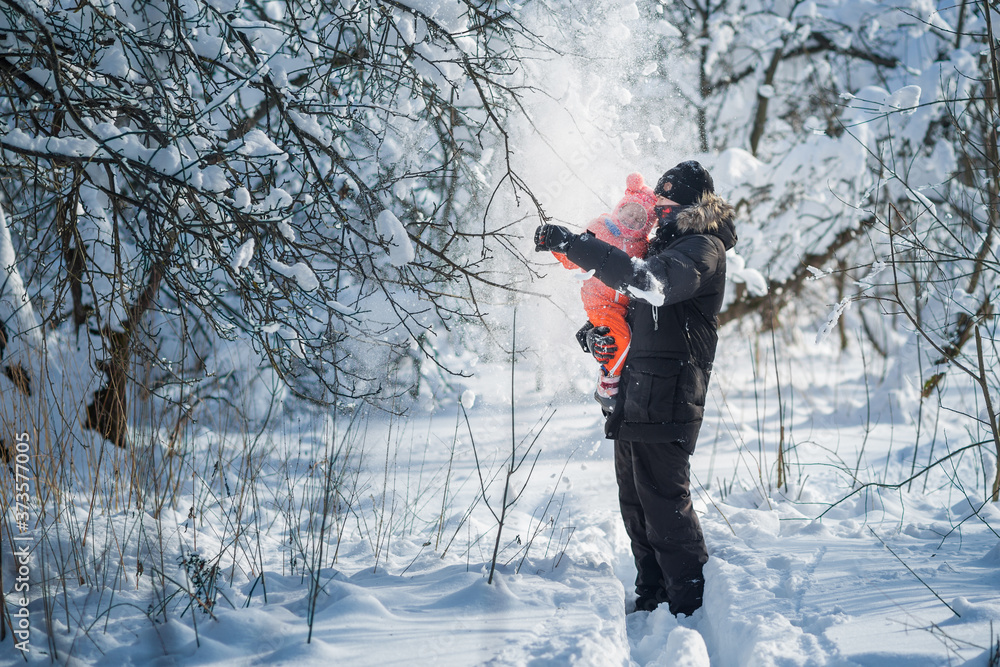 Daddy and girl smiling and hugging.Cute daughter hugs his dad on winter holiday.