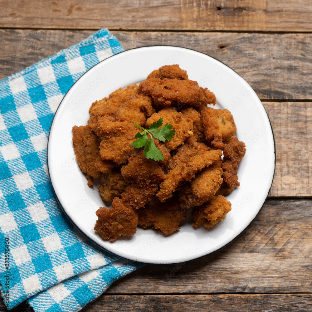 Fish chicharron with mayonnaise and onion on wooden background Fish chicharron with mayonnaise and onion on wooden background