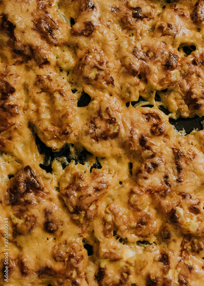 Meat cheese pizza. Baked meat in the oven lies on a black metal baking sheet. mouth-watering cheese sauce. Meat cheese pizza. Baked meat in the oven lies on a black metal baking sheet. mouth-watering cheese sauce.