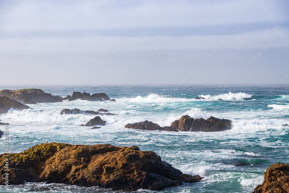 Waves breaking on rocks in ocean