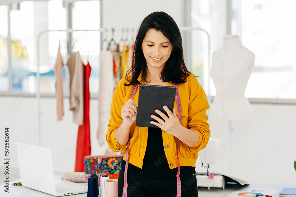 Seamstress working at her workplace. Latin woman owner of small business. Seamstress working at her workplace. Latin woman owner of small business.