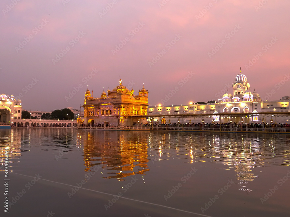golden temple with pink sunset sky in amritsar golden temple with pink sunset sky in amritsar