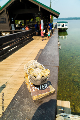 Wooden bear in a mask informing passengers to mask up to enter the boarding dock in Grand Teton National Park, Wyoming