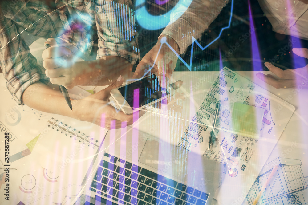 Double exposure of forex graph drawing and man and woman working together holding and using a mobile device. Trade concept. Double exposure of forex graph drawing and man and woman working together holding and using a mobile device. Trade concept.