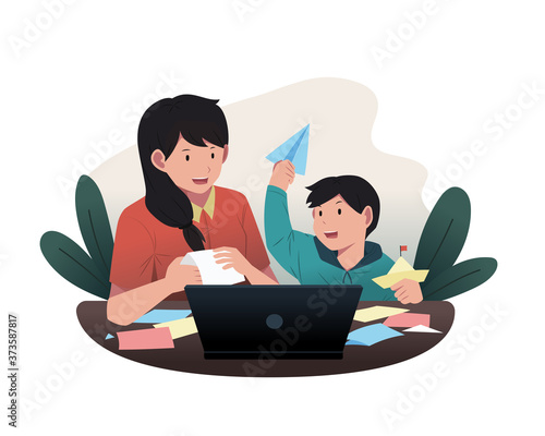 Mother accompanies her kindergarten child while doing homework. Online school activities during the pandemic