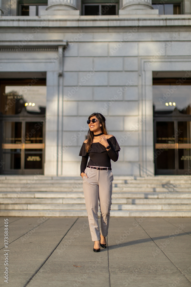young woman in front of a building young woman in front of a building