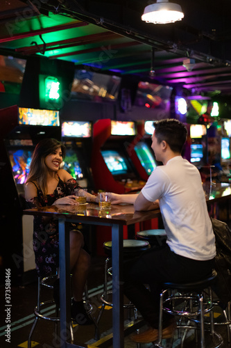 a young couple in a bar arcade