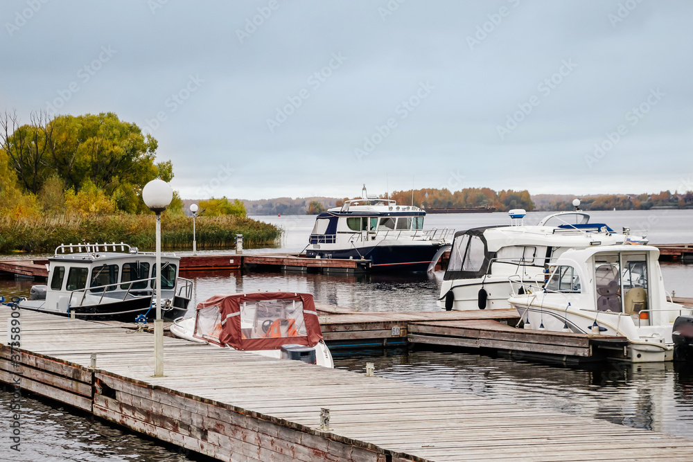 Boats at the pier in the autumn on cloudy afternoon. Boats at the pier in the autumn on cloudy afternoon.