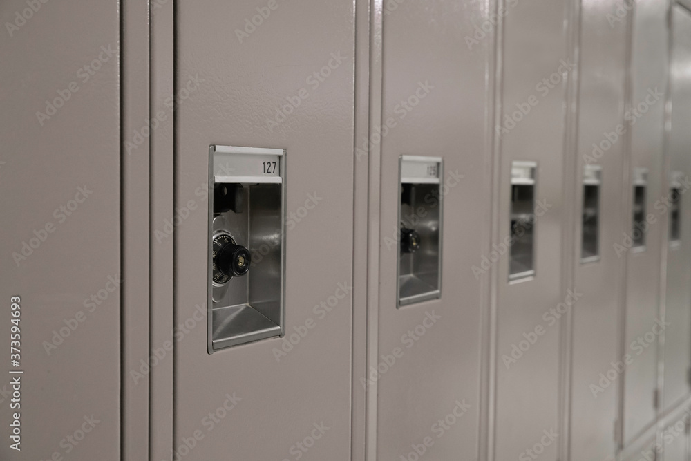 Row of Beige Middle or High School Lockers and Locks Row of Beige Middle or High School Lockers and Locks