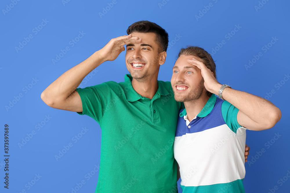 Happy gay couple on color background Happy gay couple on color background