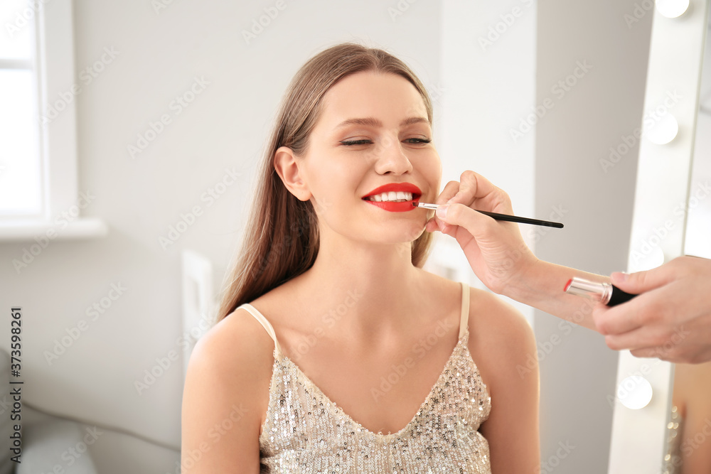 Makeup artist working with young woman in beauty salon Makeup artist working with young woman in beauty salon