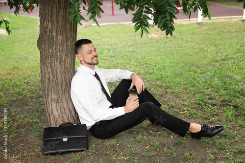 Handsome businessman relaxi...