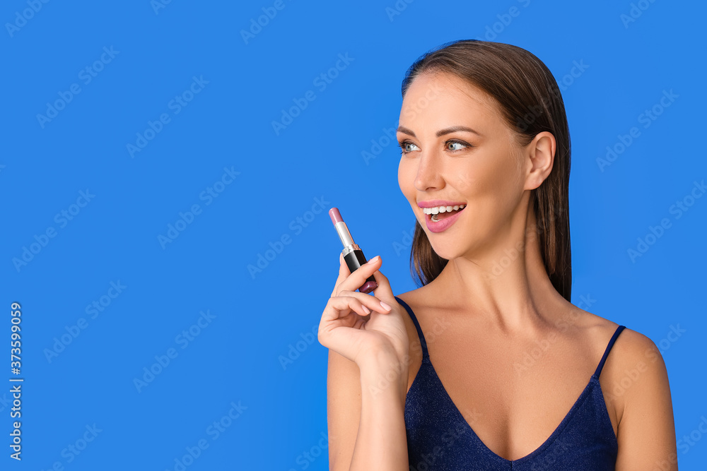 Beautiful young woman with lipstick on color background Beautiful young woman with lipstick on color background