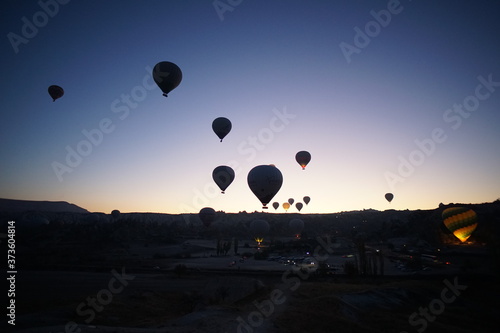 Hot air balloon flying over rock landscape at Cappadocia Turkey