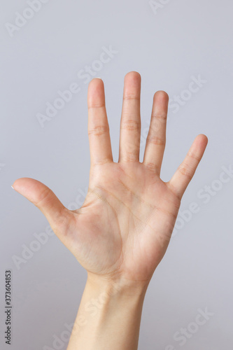 The hand shows the number five. Countdown gesture or sign. Sign language.