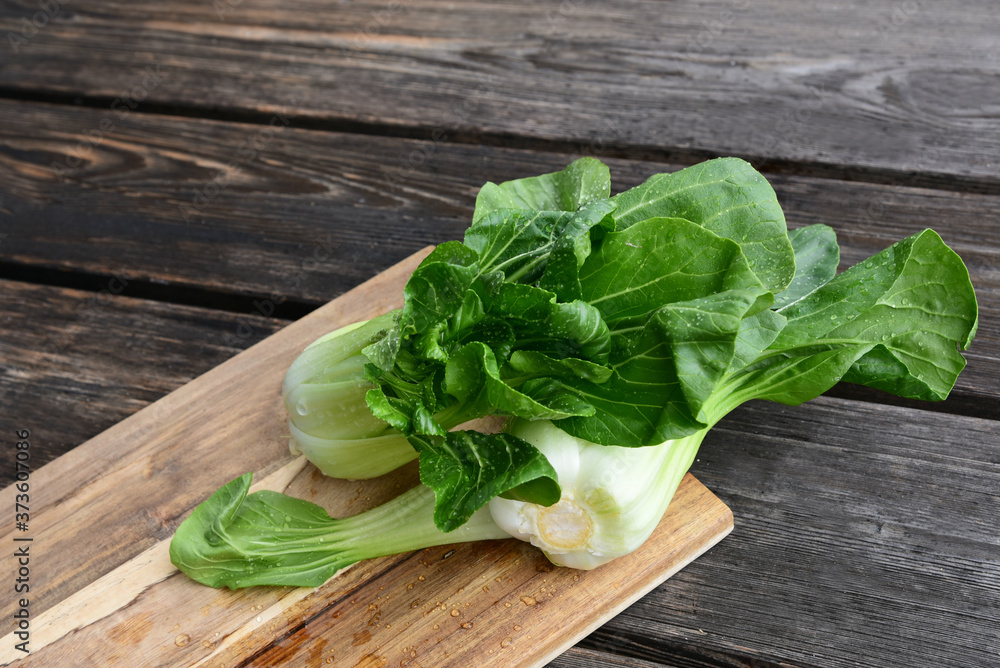 Bok choy or Chinese-cabbage on wooden board and wooden floor..Bok choy is the best leafy green vegetable. Bok choy or Chinese-cabbage on wooden board and wooden floor..Bok choy is the best leafy green vegetable.
