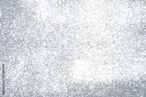 Silver Sparkling Lights Festive background with texture. Abstract Christmas twinkled bright bokeh defocused and Falling stars. Winter Card or invitation	