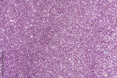 purple Sparkling Lights Festive background with texture. Abstract Christmas twinkled bright bokeh defocused and Falling stars. Winter Card or invitation	