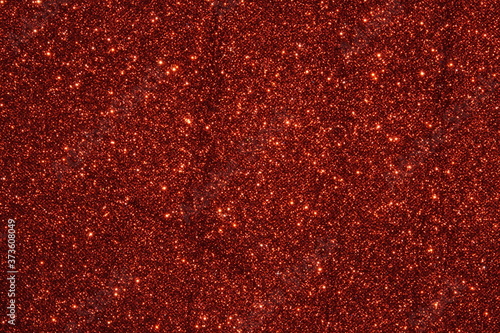 red Sparkling Lights Festive background with texture. Abstract Christmas twinkled bright bokeh defocused and Falling stars. Winter Card or invitation	