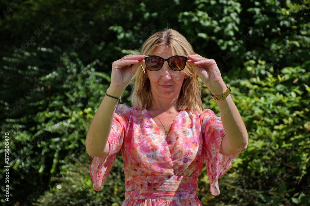 Portrait of mature woman with sunglasses against natural background Portrait of mature woman with sunglasses against natural background