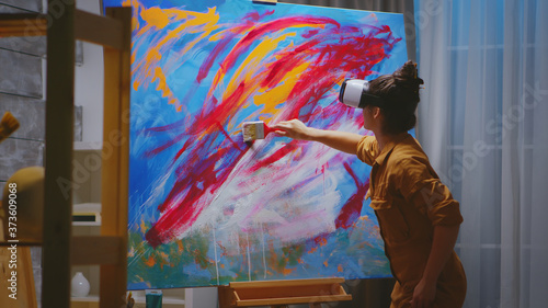 Obraz na płótnie Creative artist painting using vr headset in studio.