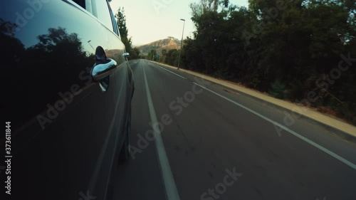 Door view of a car driving on the road photo