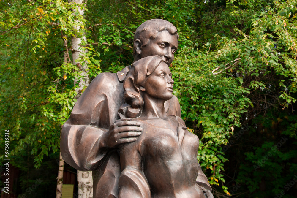 Sculpture in the forest, depicting a pair of lovers - a man and a woman. Sculpture in the forest, depicting a pair of lovers - a man and a woman.