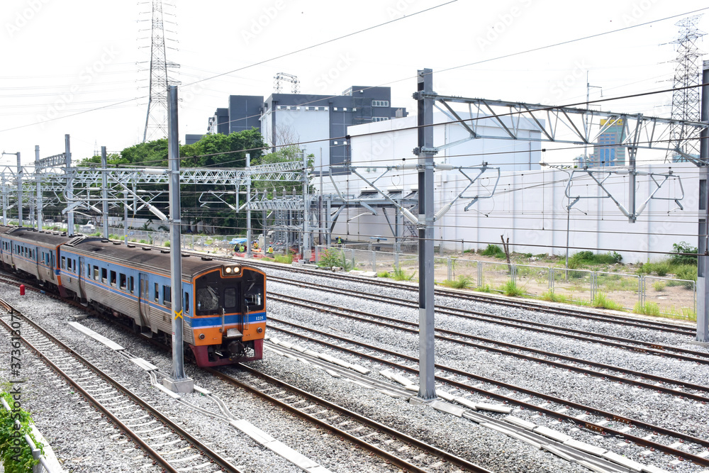 Trains running on the train tracks to the station in Thailand. Select focus with shallow depth of field.