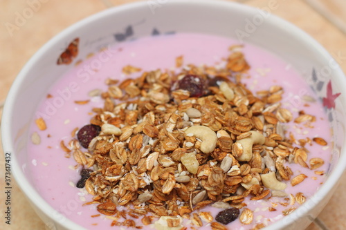 Healthy breakfast. Nuts, cereals, seeds, raisins, candied fruits and milk yogurt © 12345design