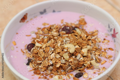 Healthy breakfast. Nuts, cereals, seeds, raisins, candied fruits and milk yogurt