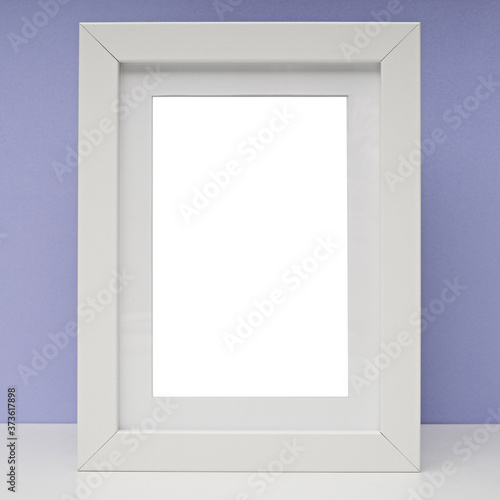 White frame for photos and drawings on a colored background. Interior Design. Mock up.
