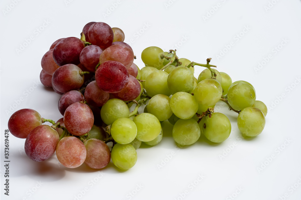 White and Red Seedless Eating Grapes on a white background freshly washed, Vegan