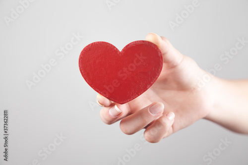 Girl hand showing red heart.