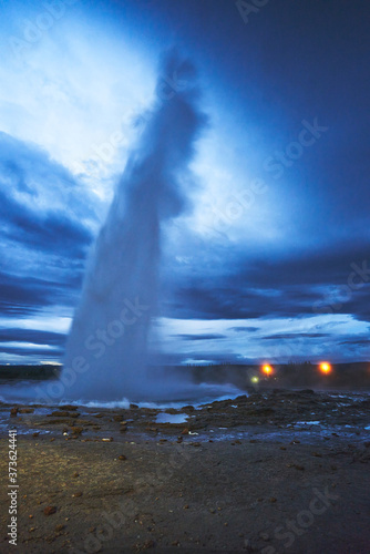 The nightscape of Geysir in Iceland emits a huge column of hot water and steam into the air and reaches its highest height