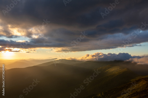 view of sunset above mountains peak © phpetrunina14