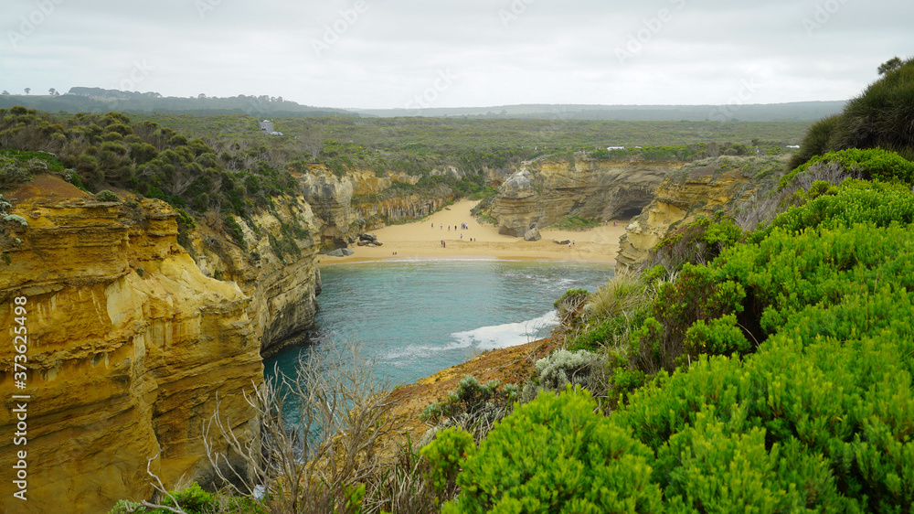 People on the beach at Loch Ard Gorge on the Great Ocean Road in Victoria, Australia
