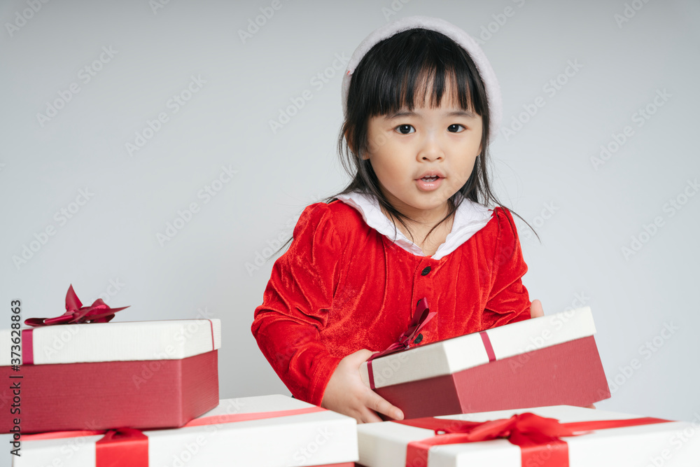 Pretty asian thai kid woman in santa claus uniform with christmas gift box for celebrating. Pretty asian thai kid woman in santa claus uniform with christmas gift box for celebrating.