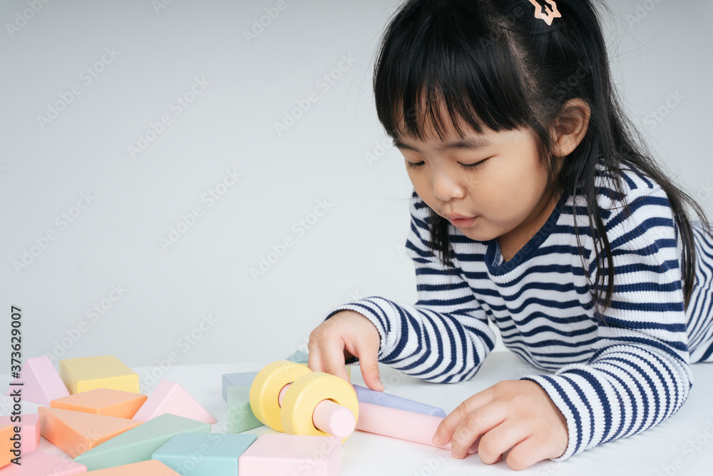 Pretty asian kid woman playing with toy block at home. Pretty asian kid woman playing with toy block at home.