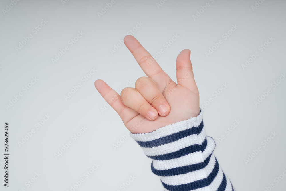 Naklejka premium Kid hand with I love you gesture.