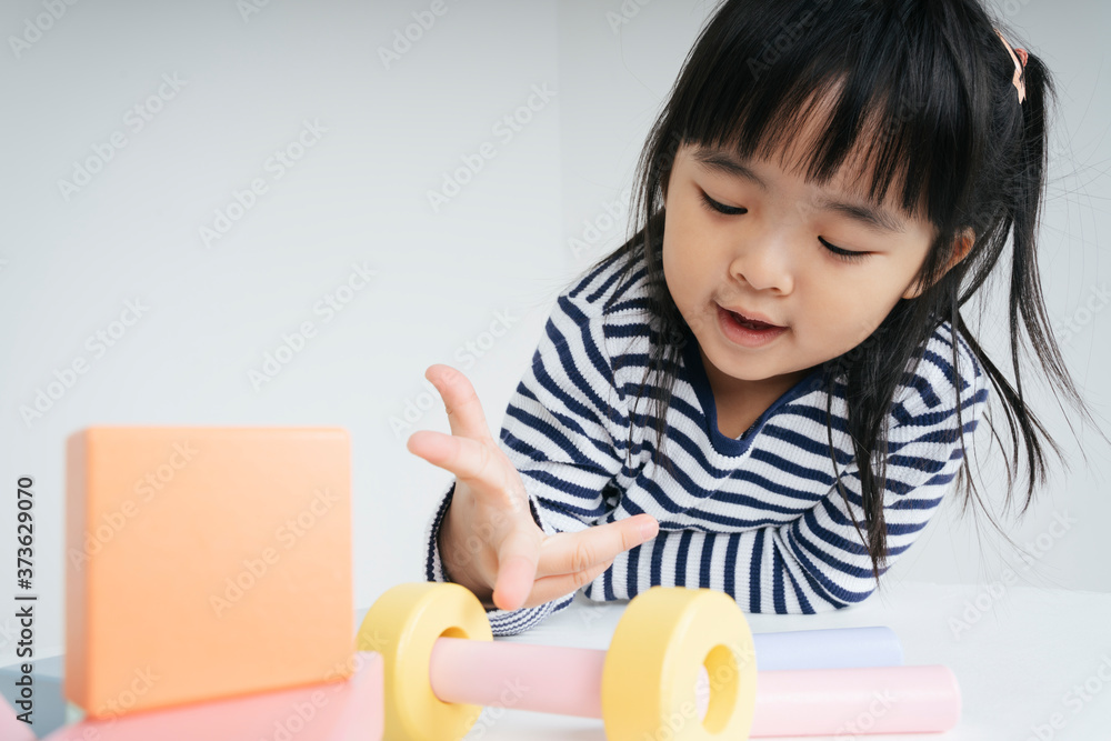 Pretty asian kid woman playing with toy block at home. Pretty asian kid woman playing with toy block at home.