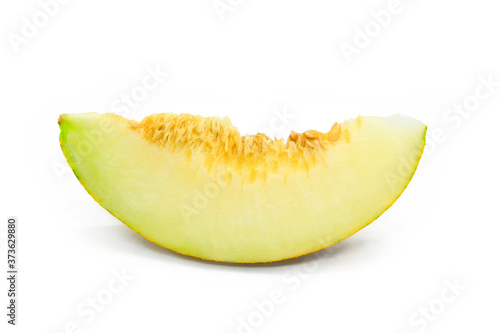 Piece of ripe melon with seeds close-up on white background