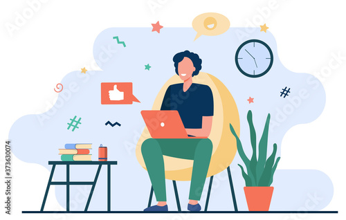 Happy freelancer with computer at home. Young man sitting in armchair and using laptop, chatting online and smiling. Vector illustration for distance work, online learning, freelance concept