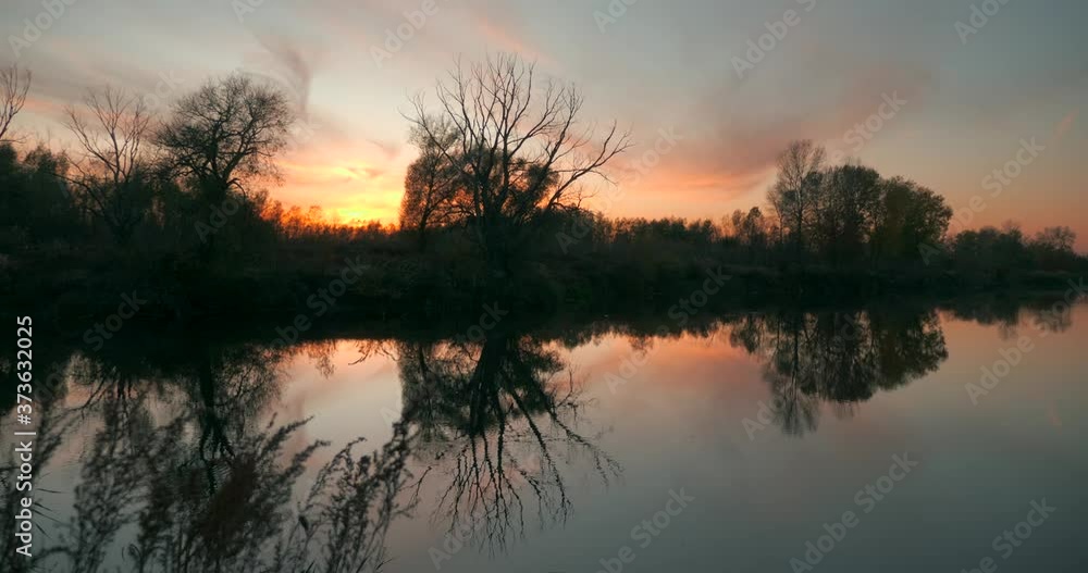 Beautiful Sunset Above Trees and River. Evening Sky Reflection on Water. Countryside Scene. Rural Landscape Beautiful Sunset Above Trees and River. Evening Sky Reflection on Water. Countryside Scene. Rural Landscape