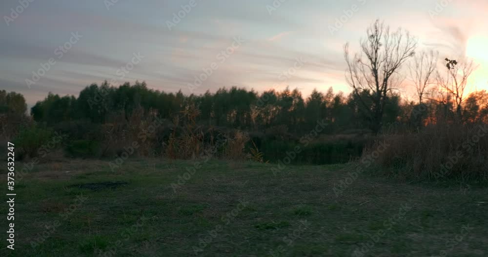 Camping Site Near River. Beautiful Sunset on Evening Sky. Countryside Scene. Rural Landscape Camping Site Near River. Beautiful Sunset on Evening Sky. Countryside Scene. Rural Landscape