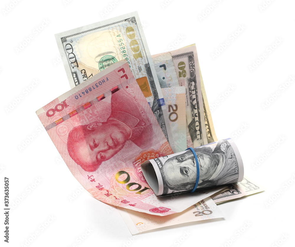 Various Chinese yuan banknotes and United States dollar bills, cash paper money isolated on white background