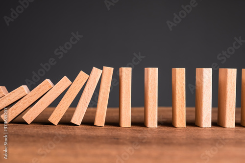 Fotografie Domino Starting to Fall Down