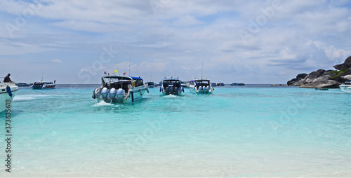 Traveling speed boats in blue sea of Similan bay in Thailand