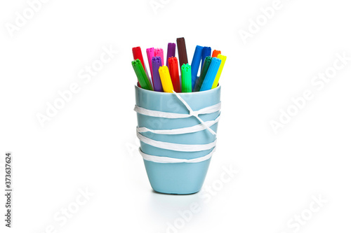 markers in a cup isolated on white background