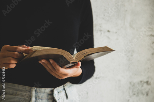 A close-up of a christian woman reading the bible.